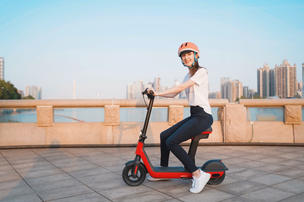 This image shows young girl riding an e-scooter.