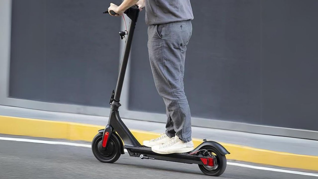 man riding an e scooter