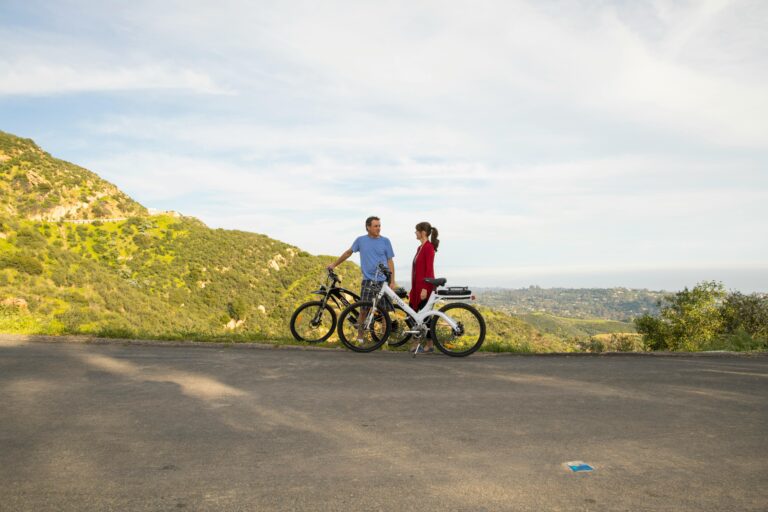 Couple enjoying a scenic ride on electric bicycles in Santa Barbara, California.